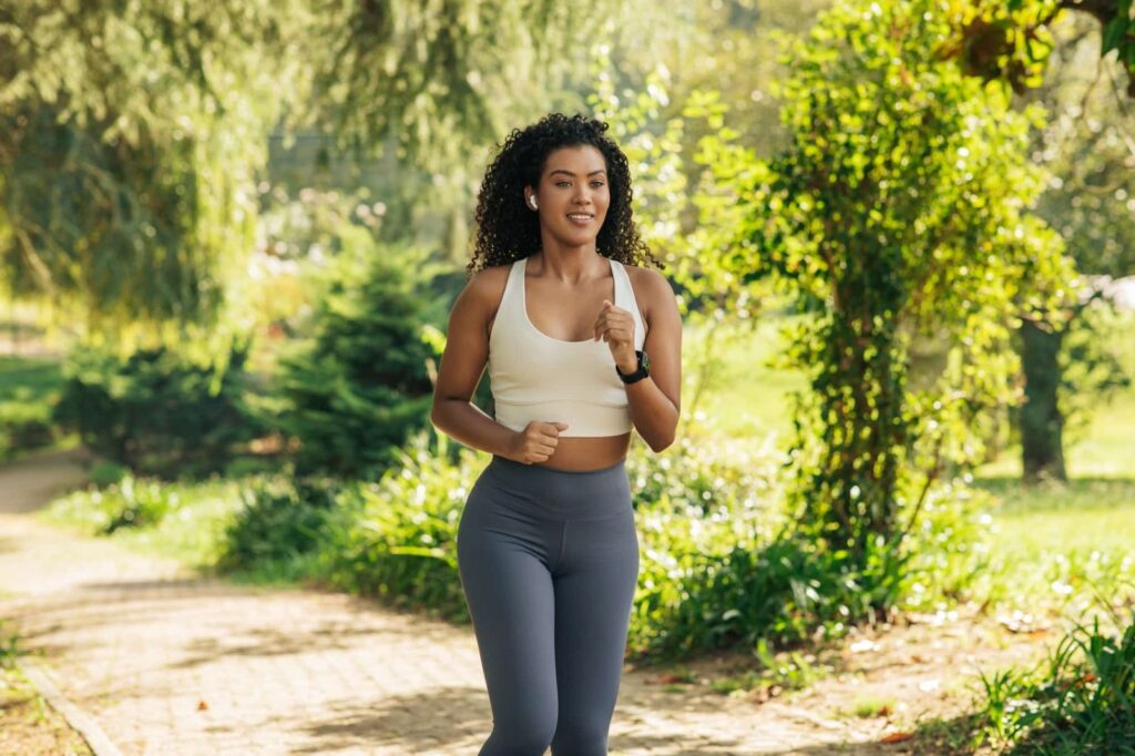 Athletic Woman Running on Path in Park